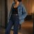 Ranch to dinner outfit fashion editorial: anonymous model in denim jacket, black tank, and indigo jeans in soft loft light