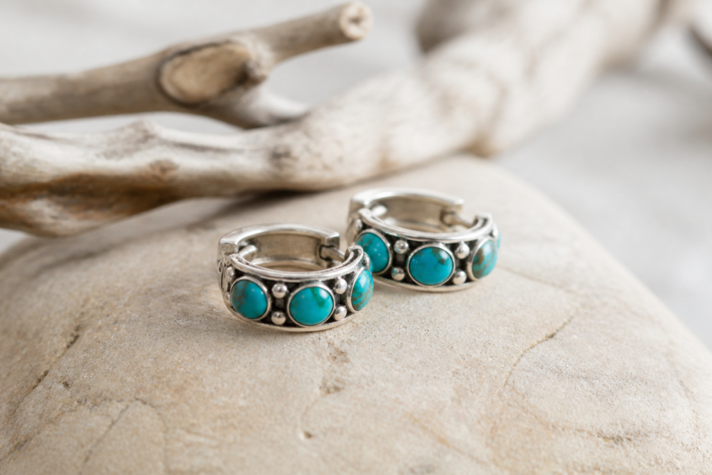 Sterling silver turquoise hoop earrings on stone