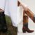 Luxury cowboy boots side by side: the black Lucchese Summer worn with a white dress, and the Tecovas Annie Wild Horses with horse inlays on the shaft