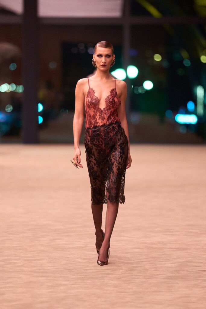 Saint Laurent Fall 2026 look 28: sheer red and black lace slip dress with a plunging neckline