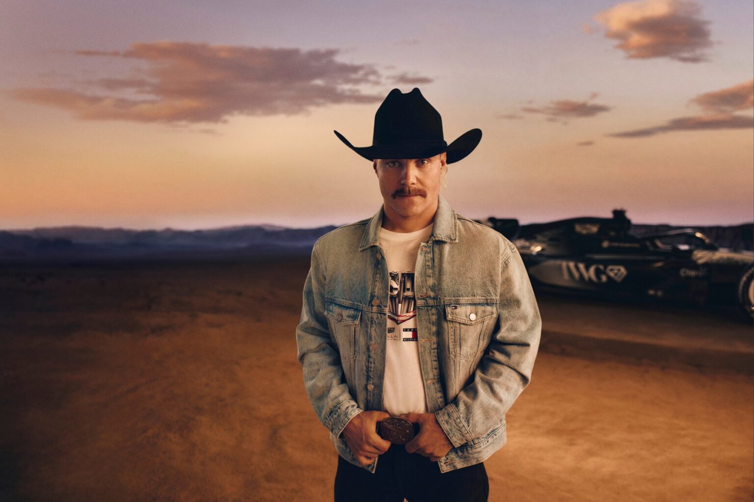 What to wear to F1 Austin inspiration: a look from the Tommy Hilfiger x Cadillac F1 Team Austin collection with a light-wash denim trucker and black cowboy hat