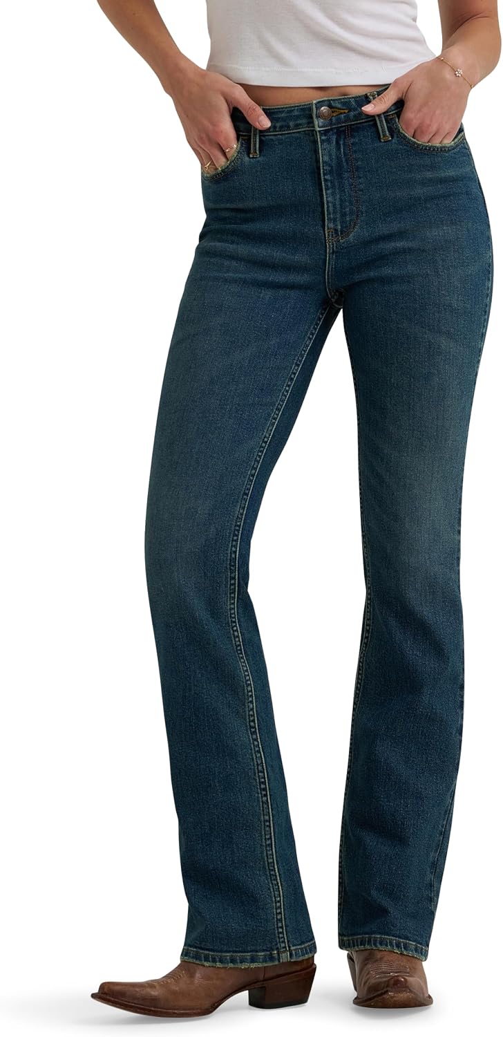 Wrangler high rise bold boot jeans in Stormy Indigo worn with cowboy boots