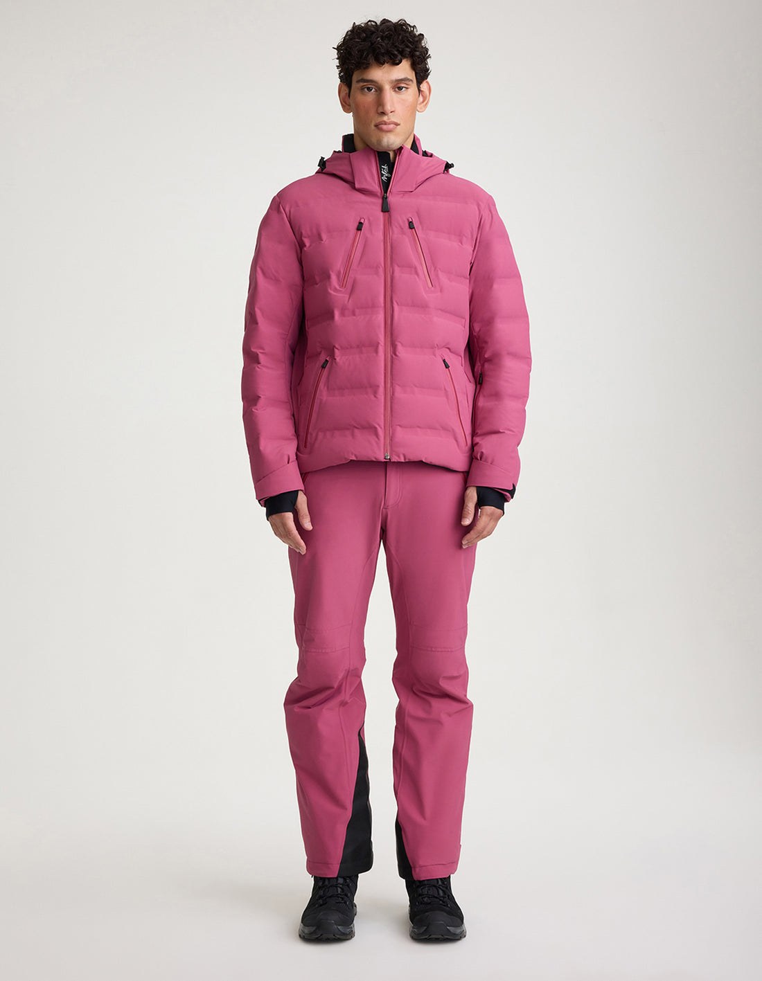 Model wearing the Aztech Mountain Nuke Suit down ski jacket in bougainvillea pink
