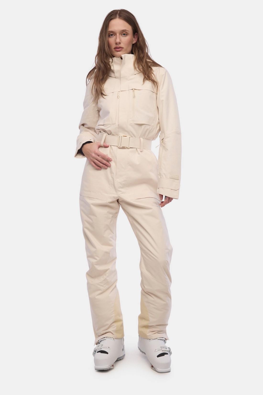 Model wearing the Halfdays Murphy one-piece ski suit in oat milk