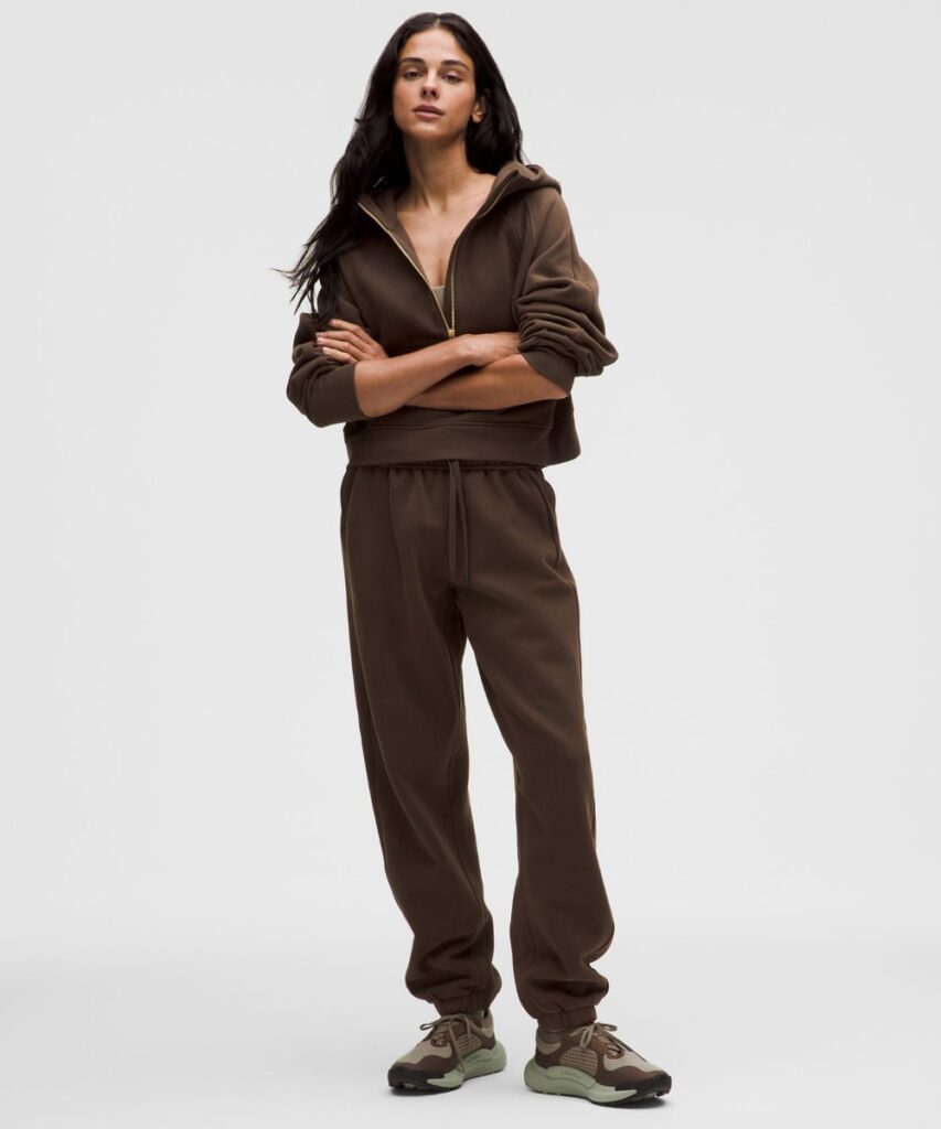 Lululemon Scuba Mid-Rise Oversized Jogger in brown cotton-blend fleece, worn with a brown zip top and sneakers