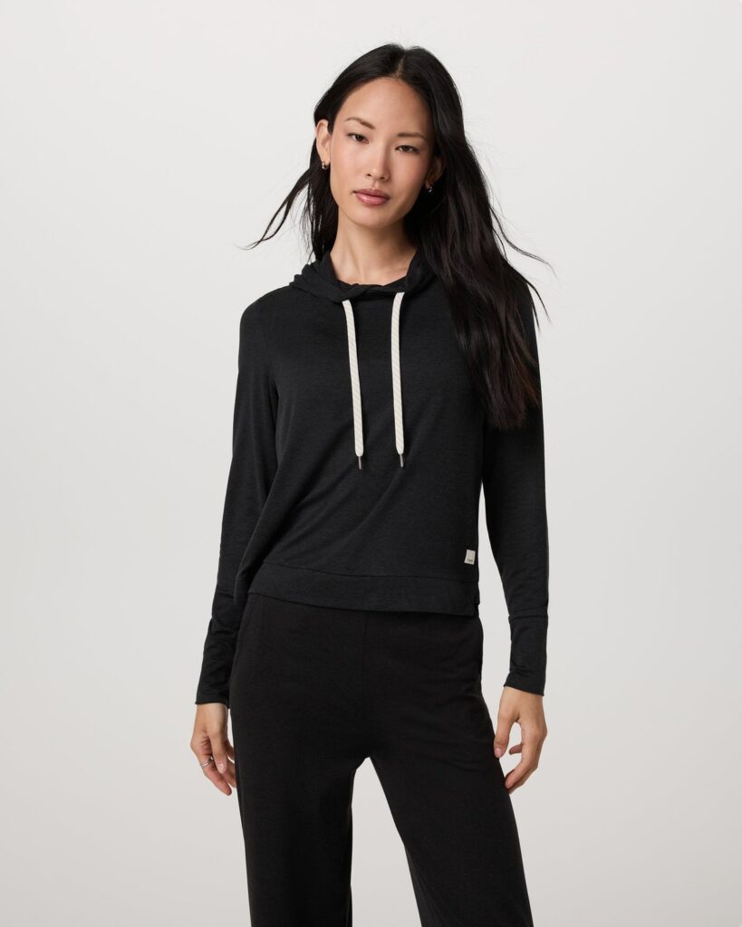 Vuori women's Halo Essential Hoodie in black heather, a slightly cropped DreamKnit pullover hoodie with cream drawstrings
